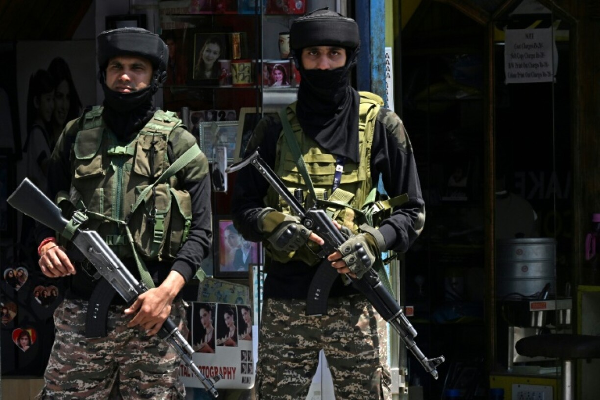 Indian paramilitary troops stand guard on a street in Srinagar in Indian-administered Kashmir
