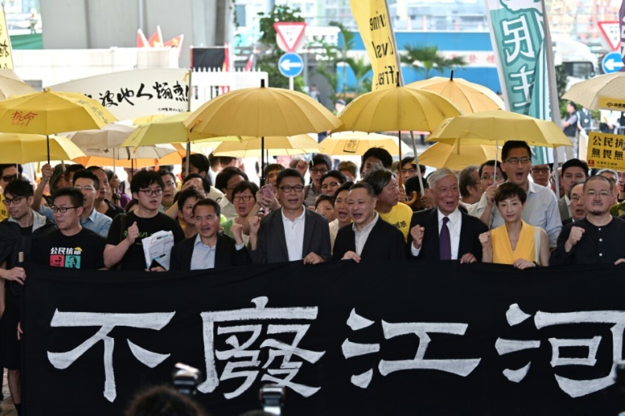 Democracy activists protest outside the West Kowloon Magistrates Court after campaigners were convicted on colonial-era 'public nuisance' charges