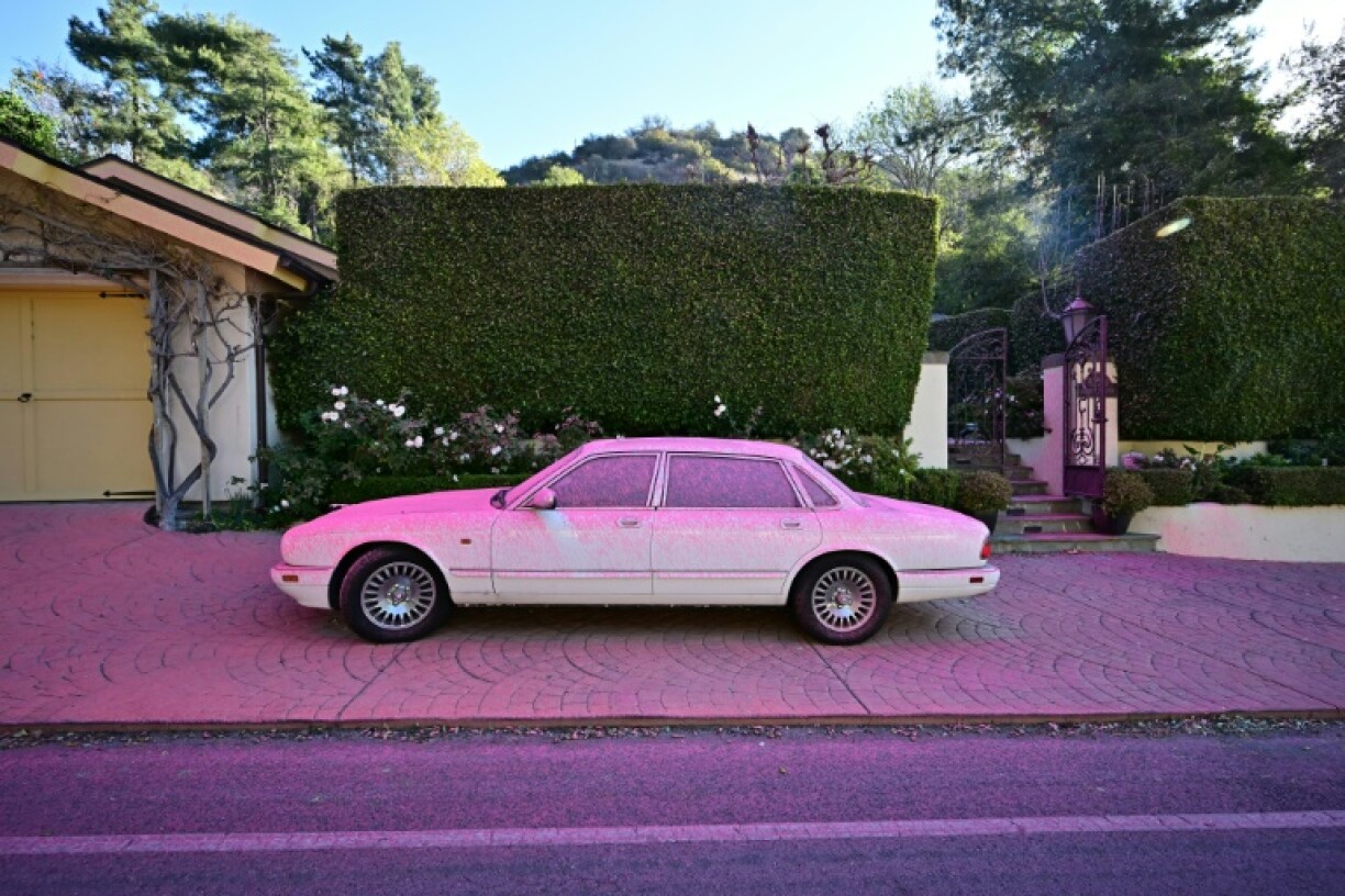 Fire retardant covers a car and sidewalk in the Mandeville Canyon neighborhood