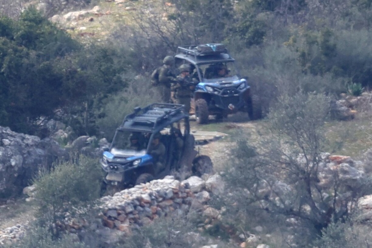 Israeli army forces patrol in the village of Kfarshuba, southern Lebanon, the day before a deadline for withdrawal of its troops