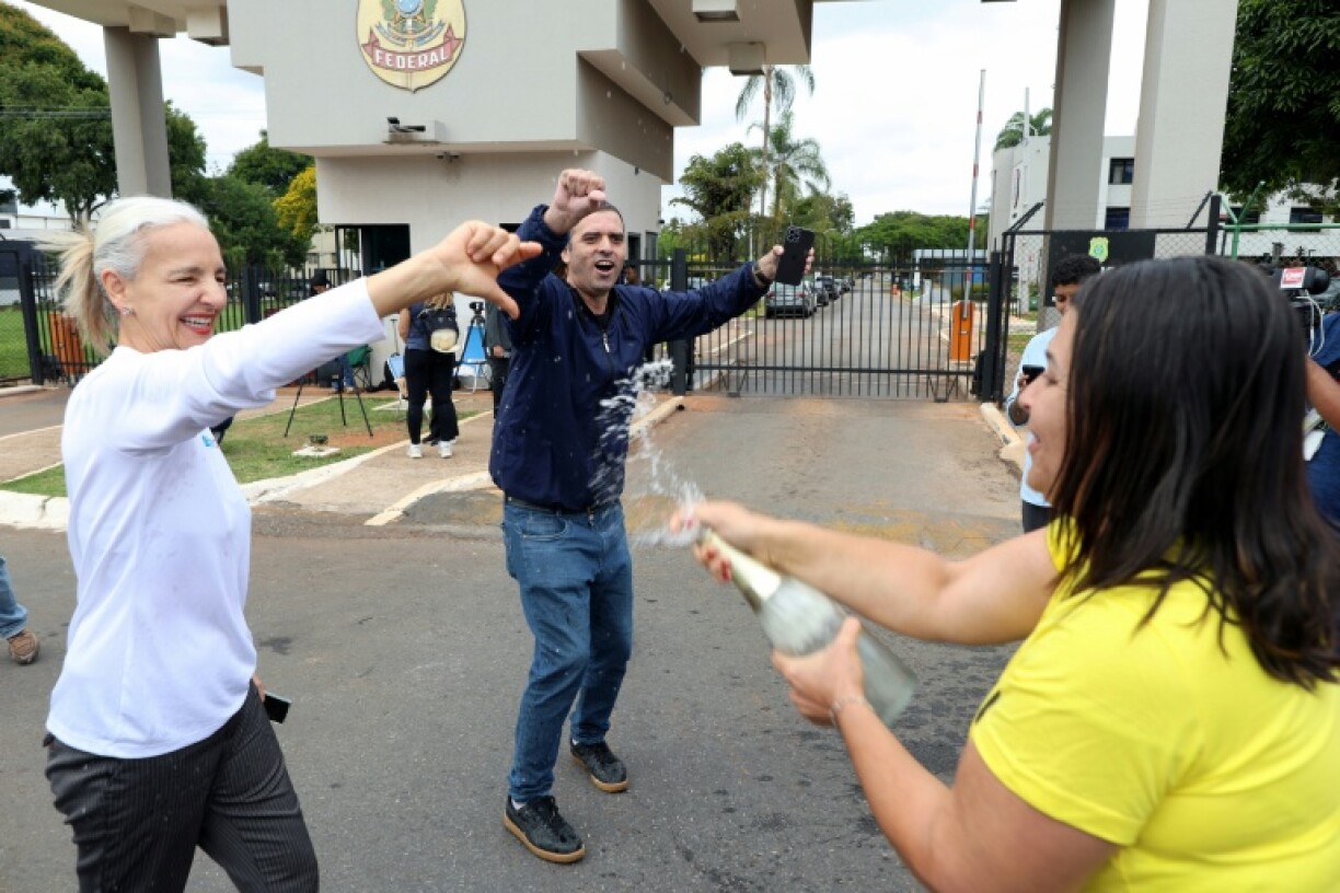 Protesters celebrate Bolsonaro's arrest with sparkling wine