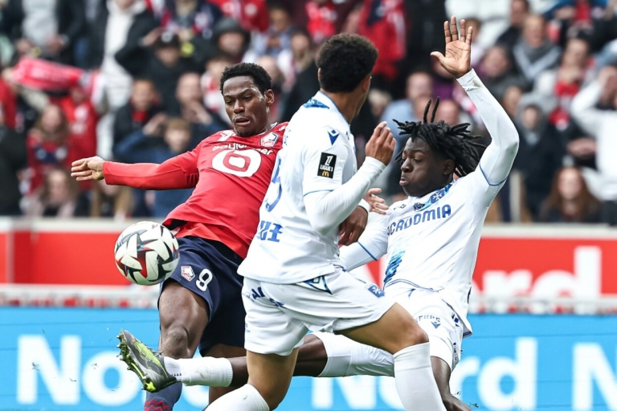 Jonathan David (L) scores Lille's third goal deep in stoppage time against Auxerre