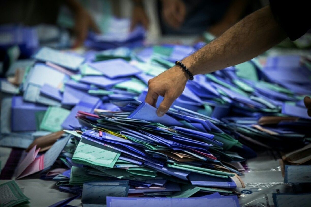A worker processes ballots after polls close in Mexico's unprecedented judicial elections