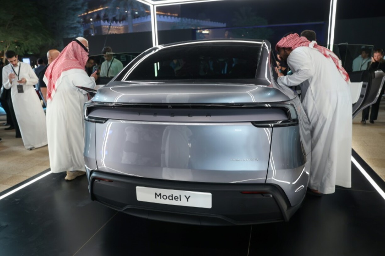 Saudis check a car at the Tesla company's first showroom in Riyadh. Elon Musk's firm has opened three showrooms in oil rich Saudi Arabia