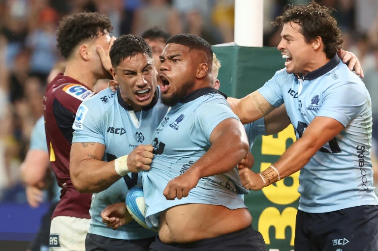 NSW Waratahs' Siosifa Amone (C) celebrates his winning try against the Otago Highlanders