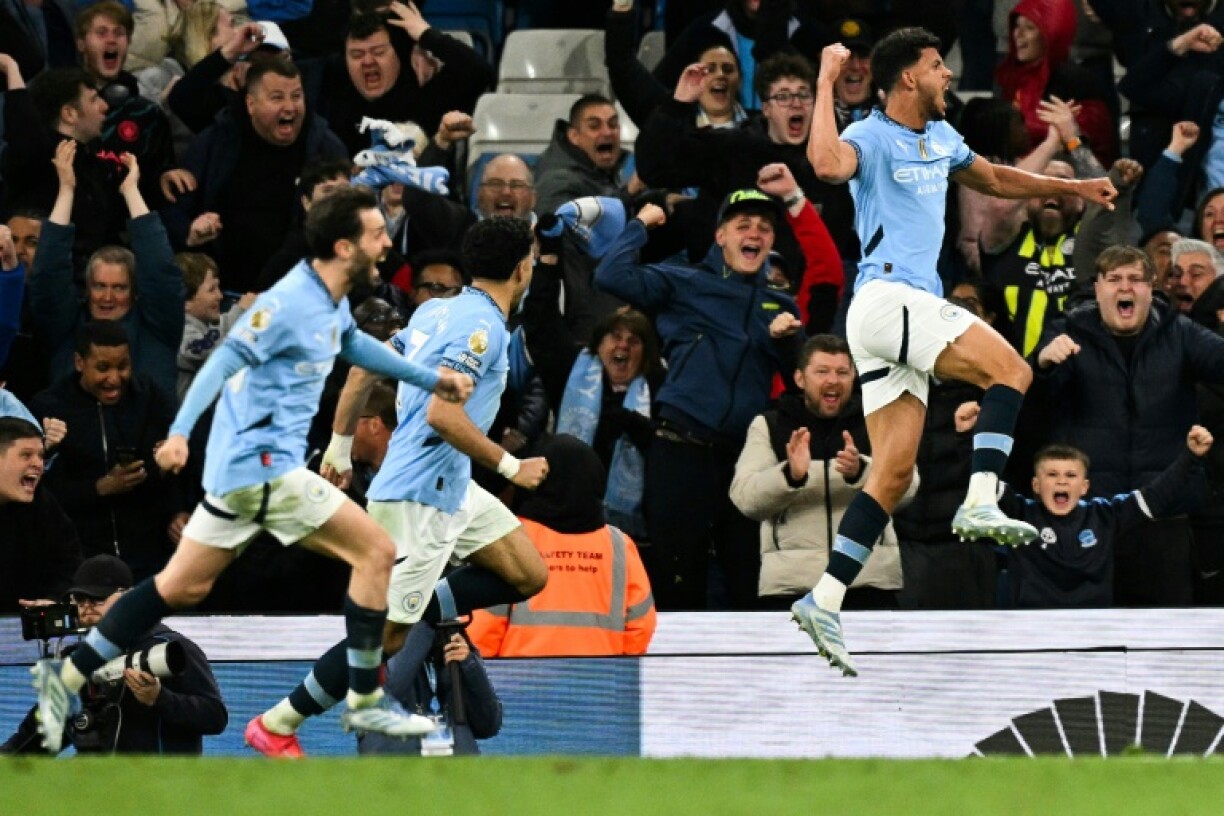 Manchester City's Matheus Nunes (R) celebrates after scoring against Aston Villa