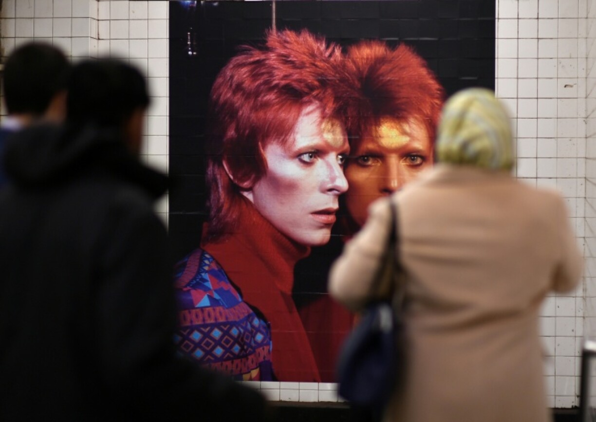 People walk by a David Bowie art installation in New York City