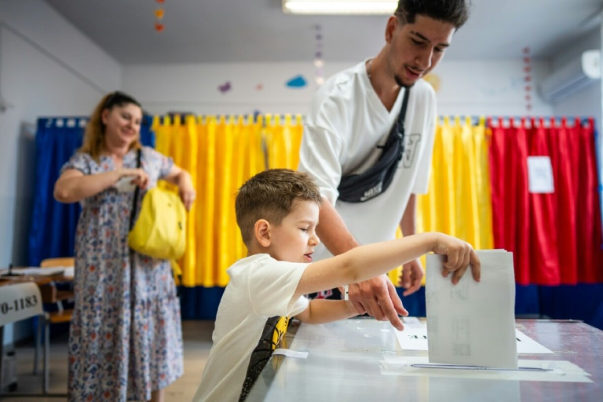 Romanians returned to the polls in a tense rerun of last year's annulled presidential election
