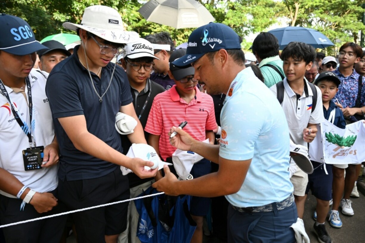 Miguel Tabuena signs autographs for fans after finishing his third round at International Series Philippines.