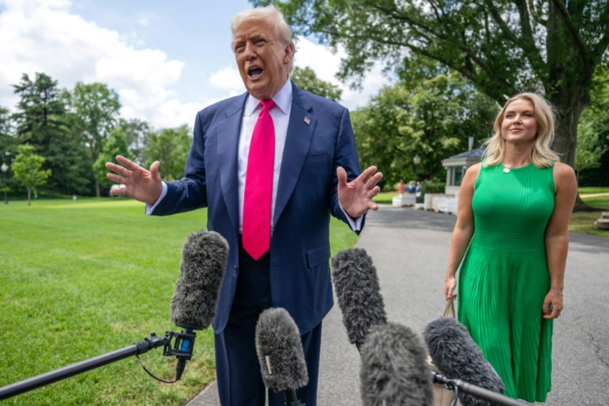 US President Donald Trump, alongside White House Press Secretary Karoline Leavitt, speaks to reporters on his way to board Marine One on the South Lawn of the White House on July 15, 2025, in Washington