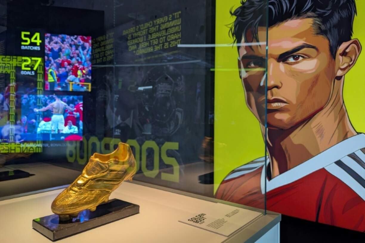 Cristiano Ronaldo's Golden Boot trophy is seen on display beside a portrait of the footballer during the opening of the CR7 LIFE Museum in Hong Kong