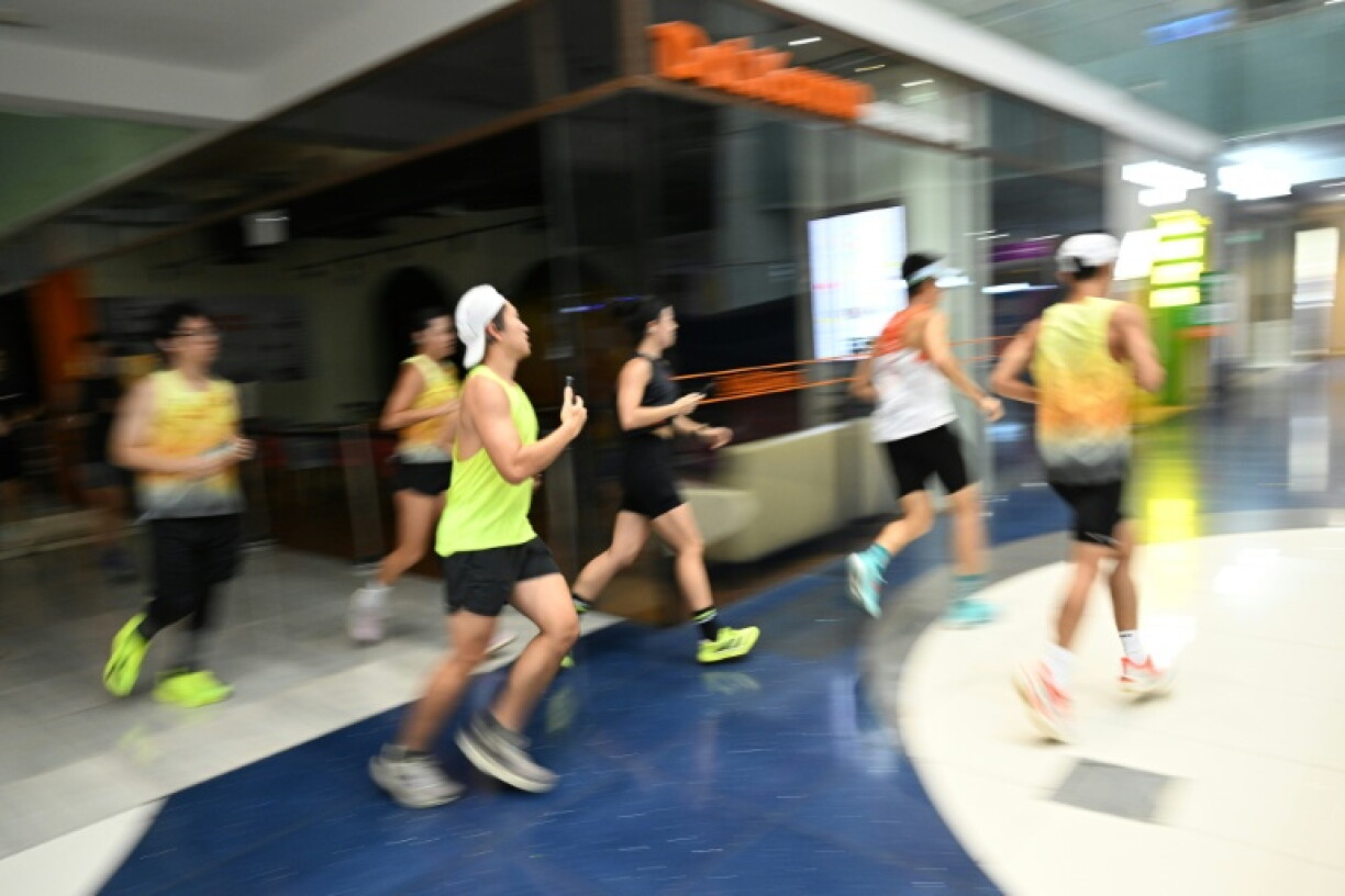 The pounding of running shoes echoes through a Singapore shopping mall