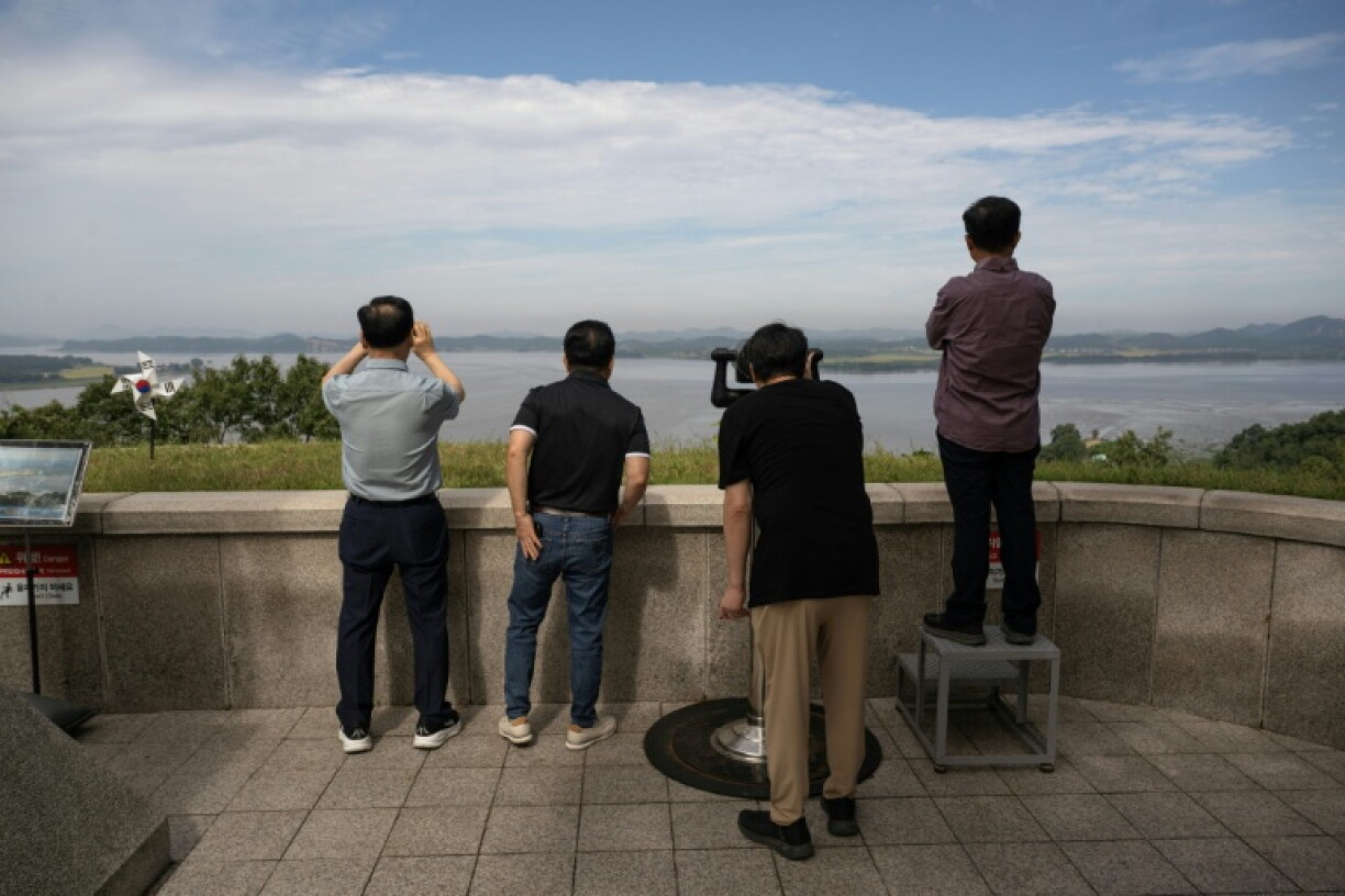 Visitors look towards North Korea, which has worked to seal off links to the outside world