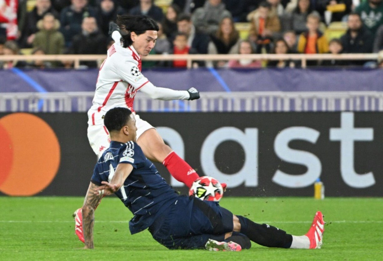Takumi Minamino (in white) has his shot blocked by Ezri Konsa as Monaco beat Aston Villa in the Champions League
