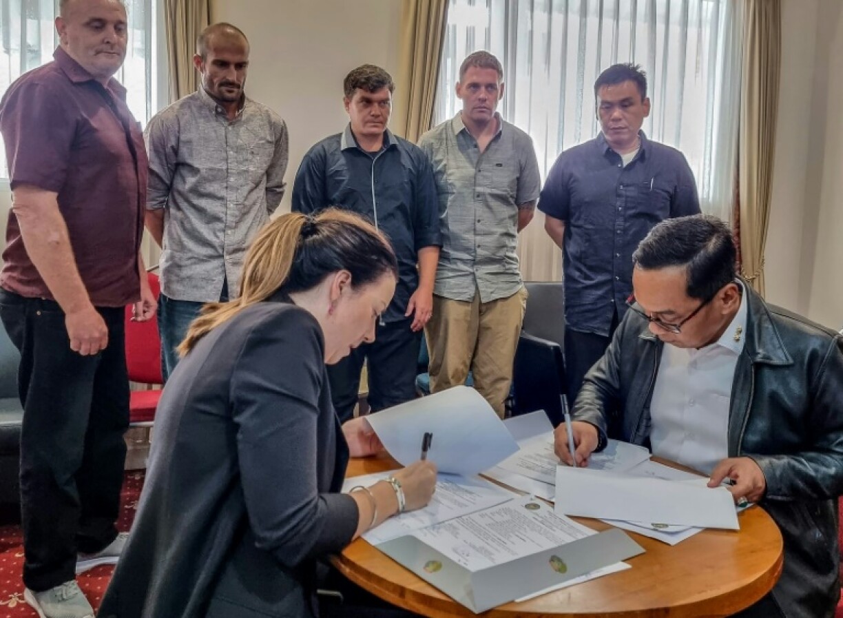 The five remaining members of the Australian 'Bali Nine' drug ring, pictured standing, returned to Australia after 19 years in jail in Indonesia