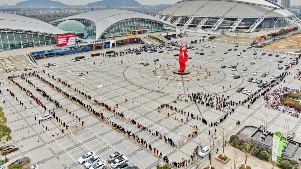 This aerial photo taken on February 15, 2022 shows residents queueing to undergo nucleic acid tests for the Covid-19 coronavirus in Nantong in China's eastern Jiangsu province.
