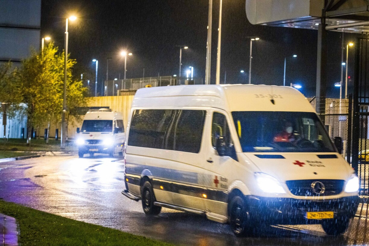 A Red Cross van transporting passengers of flights from South Africa who have tested positive for Covid-19 drives to a hotel where they will be quarantined on November 278, 2021, at Amsterdam's Schiphol airport.