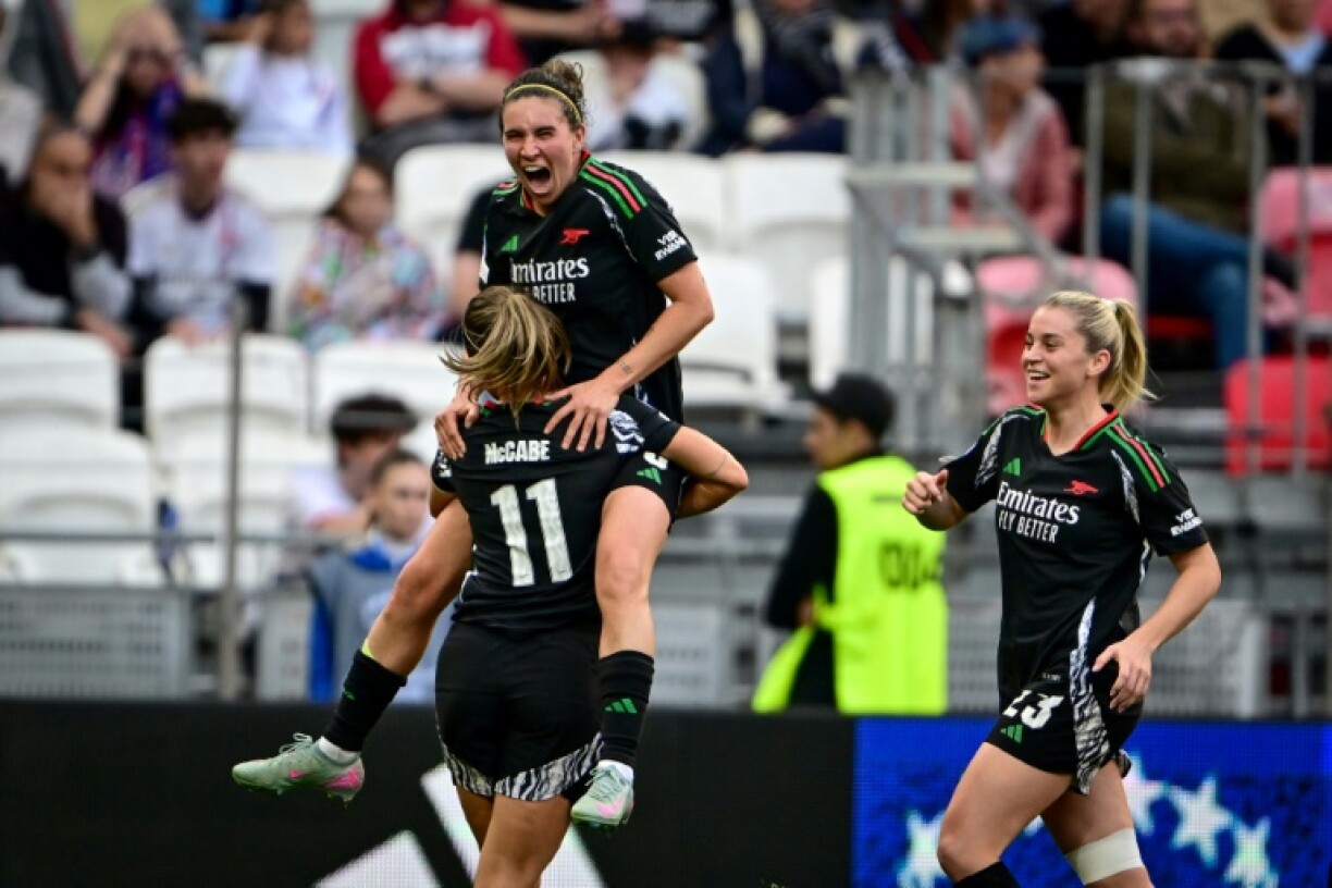Mariona Caldentey (2L) celebrates with teammates after scoring Arsenal's second goal against Lyon on Sunday