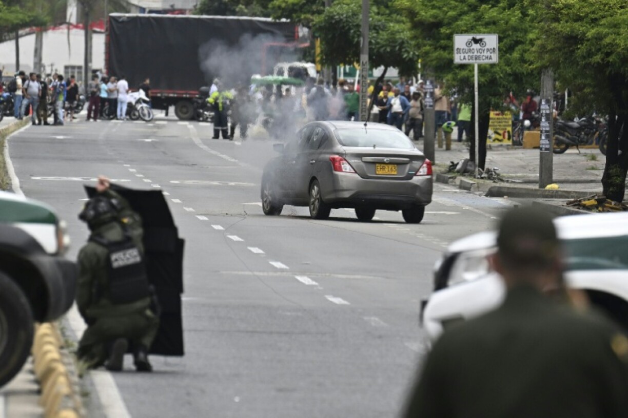 Colombian anti-explosives policemen carry out a controlled detonation during a search for explosives in an abandoned vehicle on a street in Cali, Colombia on June 13, 2025