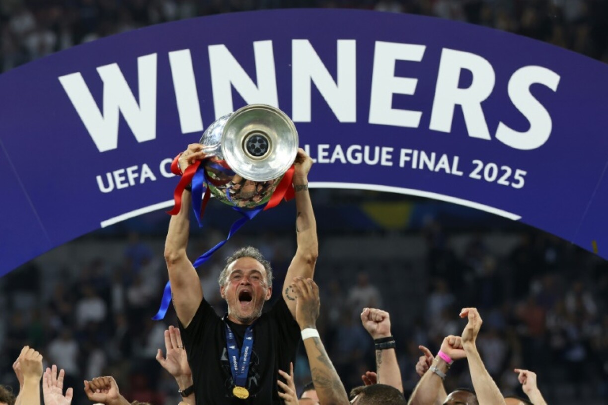 Paris Saint-Germain coach Luis Enrique lifts the Champions League trophy