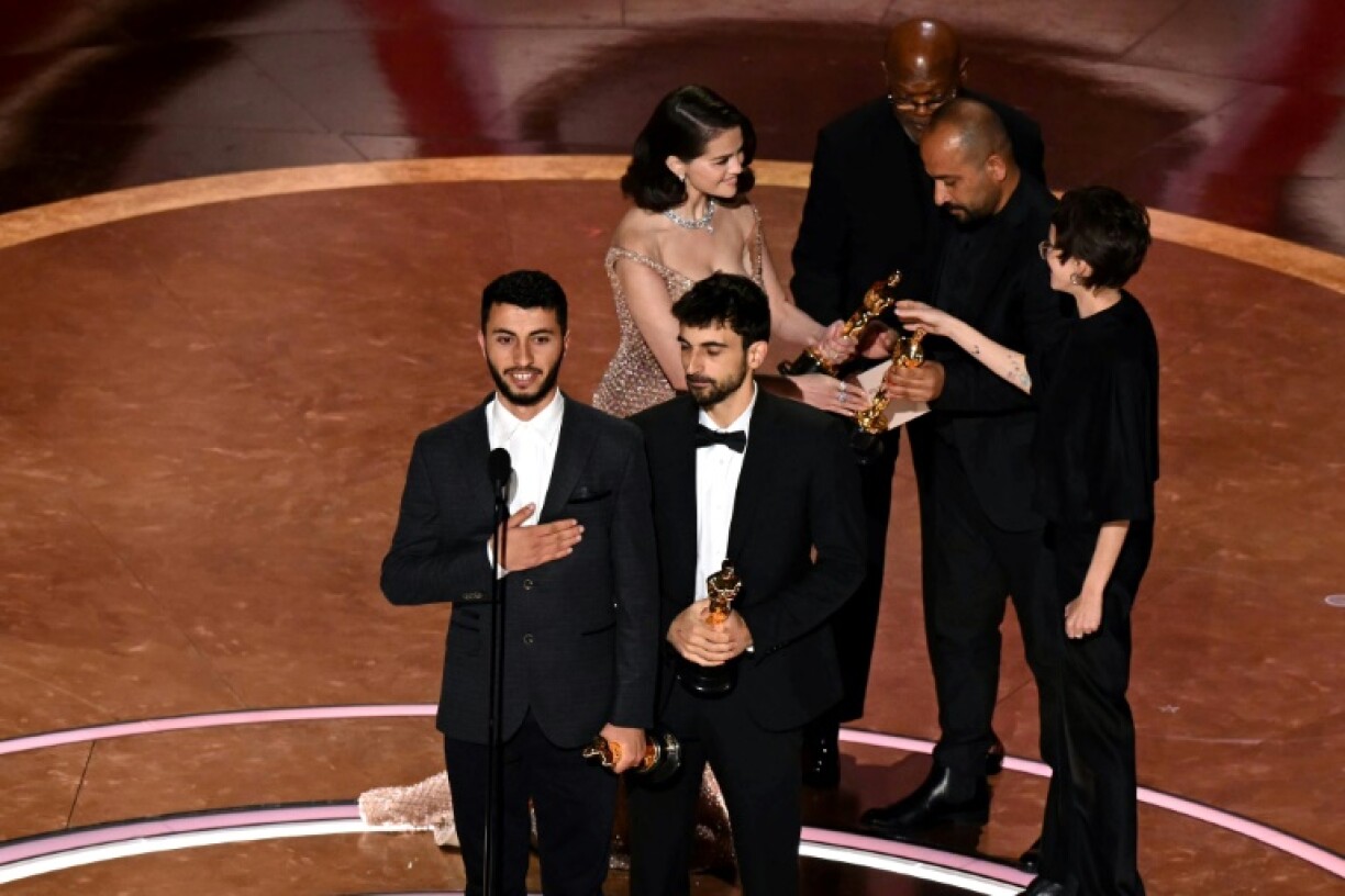 Israeli journalist and filmmaker Yuval Abraham (R) and Palestinian journalist and filmmaker Basel Adra accept the Oscar for Best Documentary Feature for 'No Other Land'