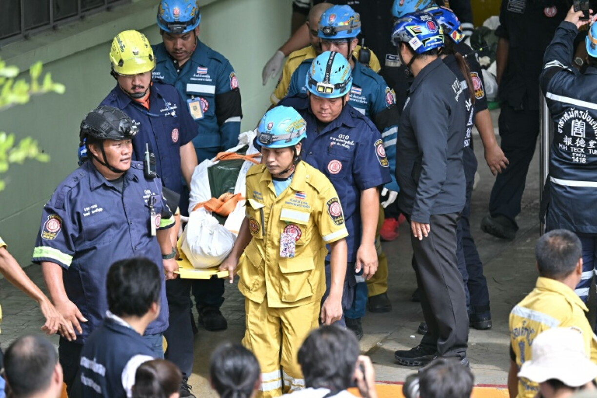 The bodies of school shooting victims are carried out of the school premises in Bang Kruai district, Nonthaburi province, north of the Thai capital Bangkok, on August 7, 2026. A teenager described as