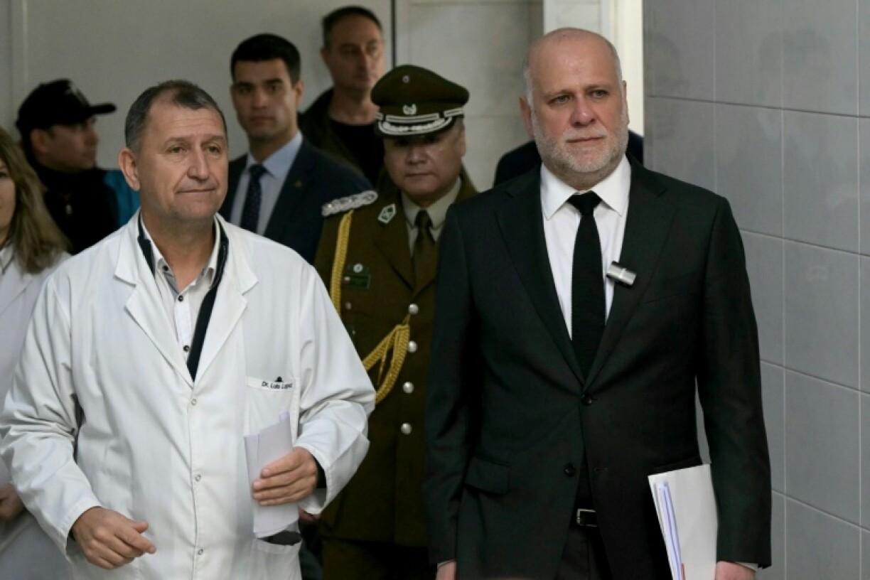 Chile's Minister of the Interior Alvaro Elizalde (R) visits a hospital in Avellaneda, Argentina where two Chilean men gravely injured in a football brawl are receiving treatment