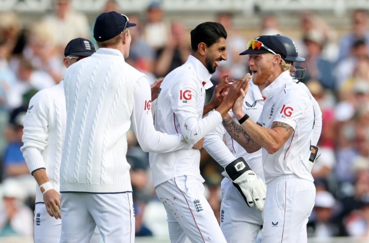 England's Shoaib Bashir (C) celebrates with after dismissing Zimbabwe's Tafadzwa Tsiga at Trent Bridge