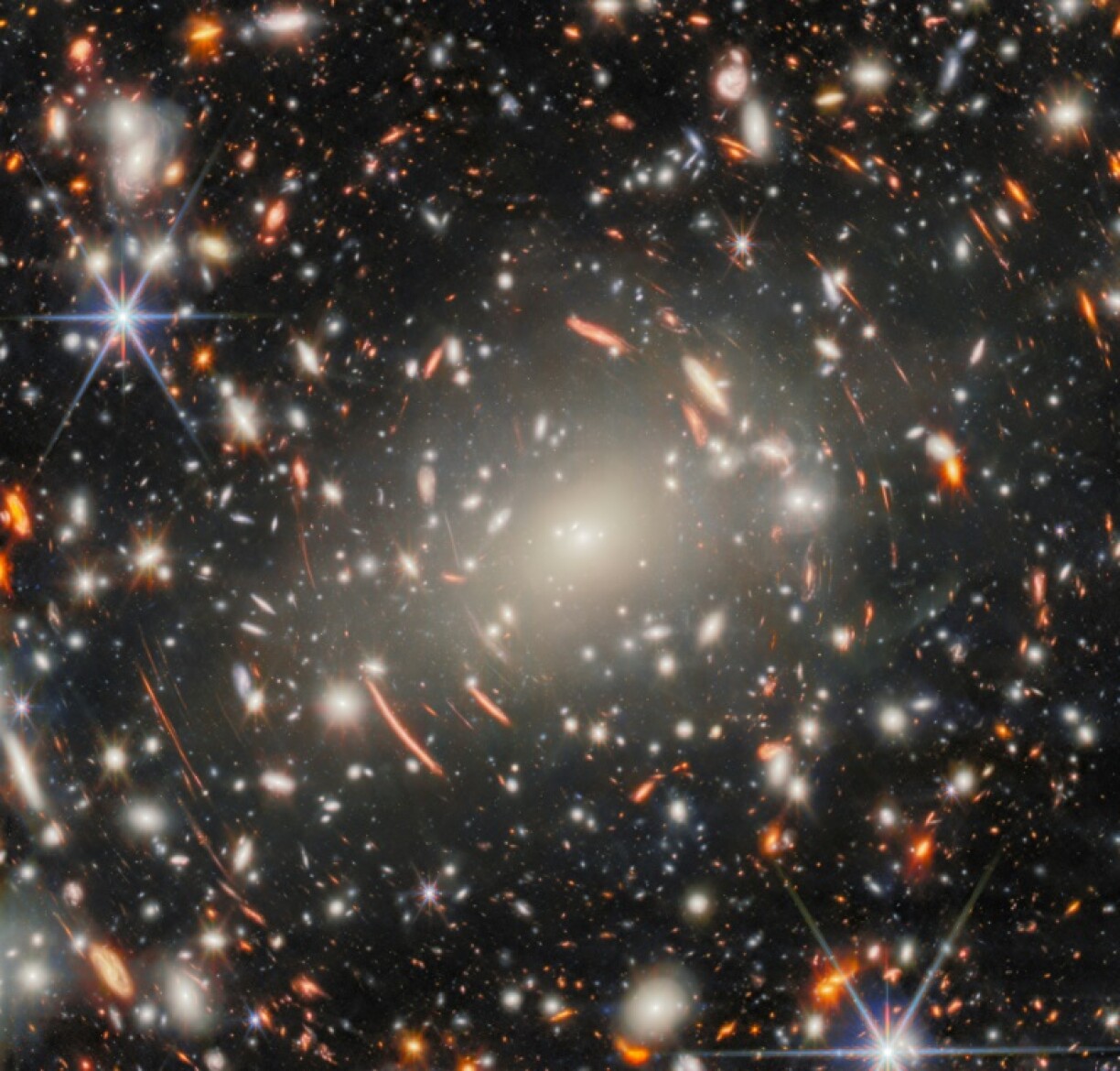 The new image uses a massive galaxy cluster as a magnifying glass to spy on ancient galaxies in the distance universe