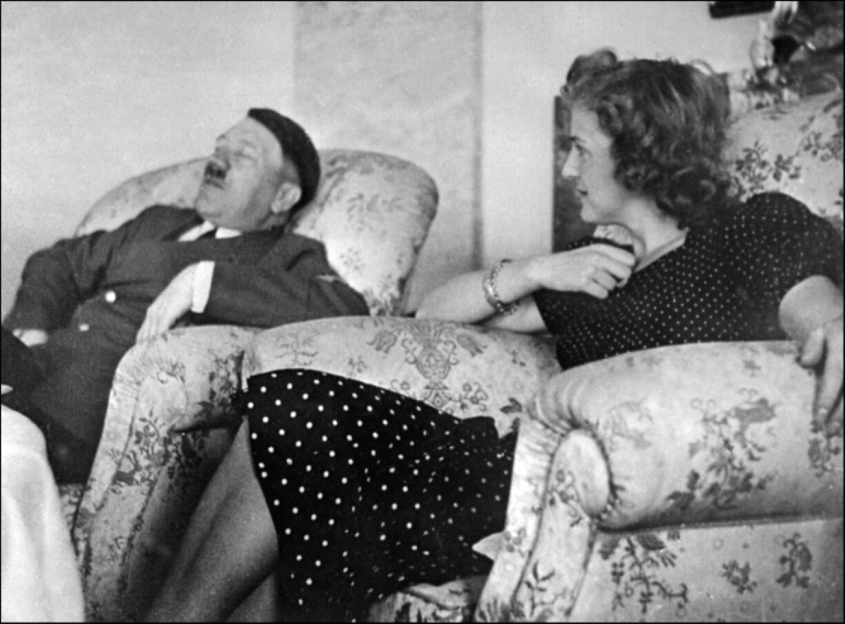 This undated and unlocated picture shows Hitler relaxing with his mistress Eva Braun