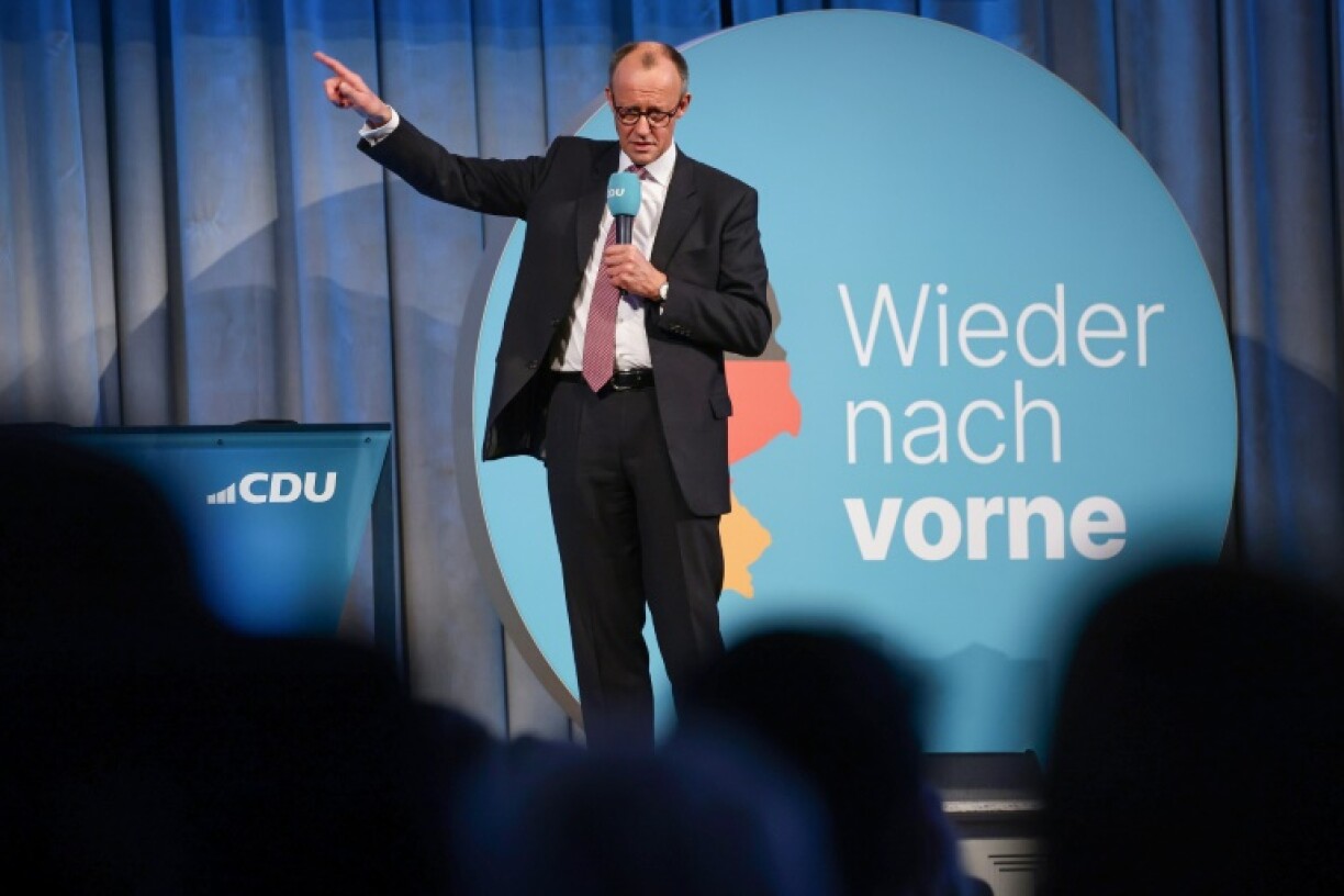 CDU leader Friedrich Merz before a slogan that reads 'Forward Again', at an election rally in Halle, eastern German on February 18, 2025