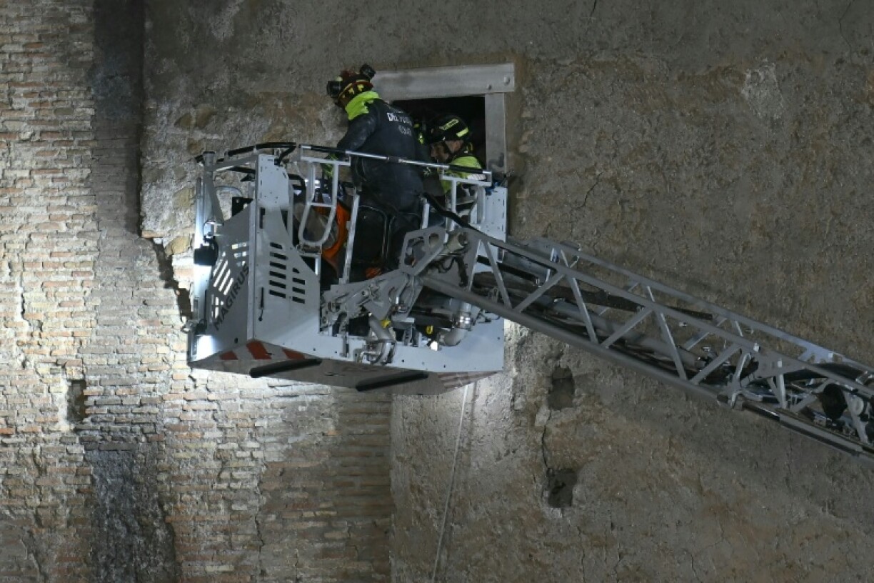 Rescuers worked to evacuate a worker who was trapped in the medieval tower Torre dei Conti after the tower partially collapsed in the historic center of Rome