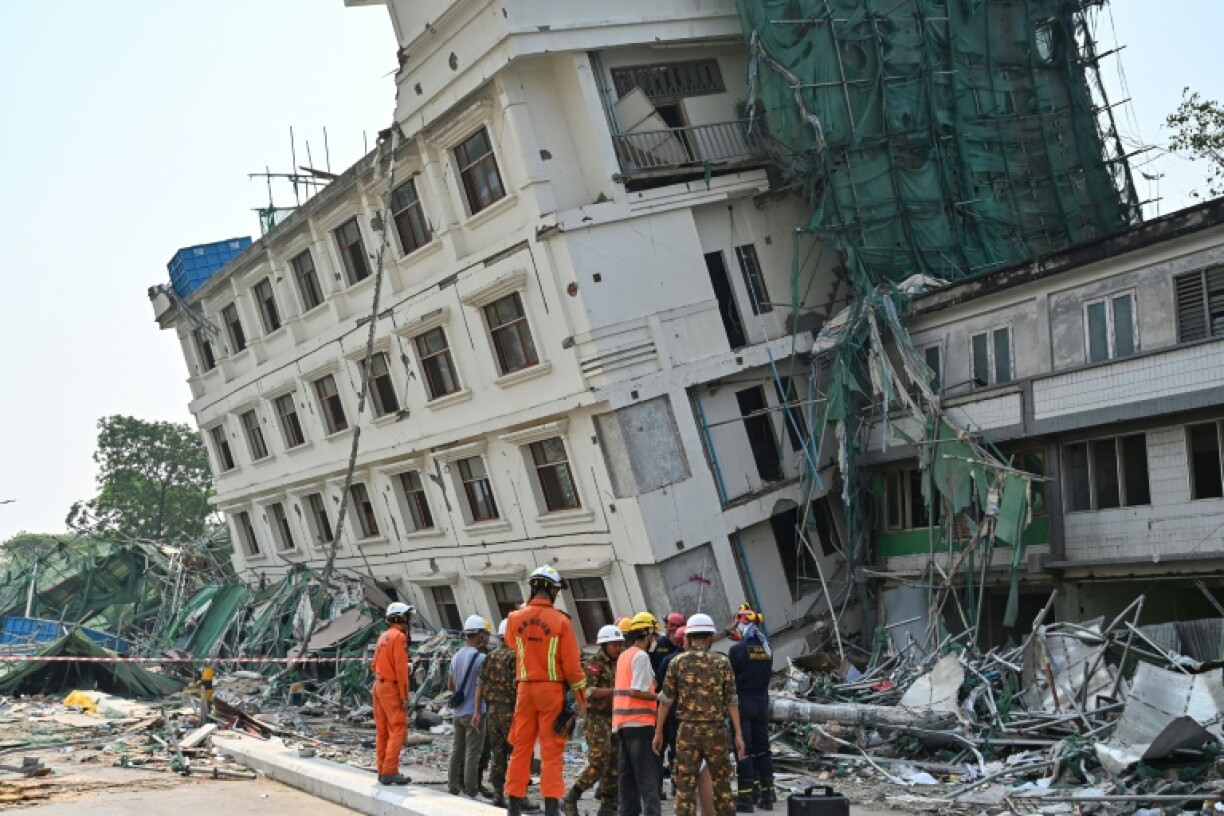 China's and Belarus' rescue teams coordinate at the site of a collapsed building in Mandalay on April 2, 2025