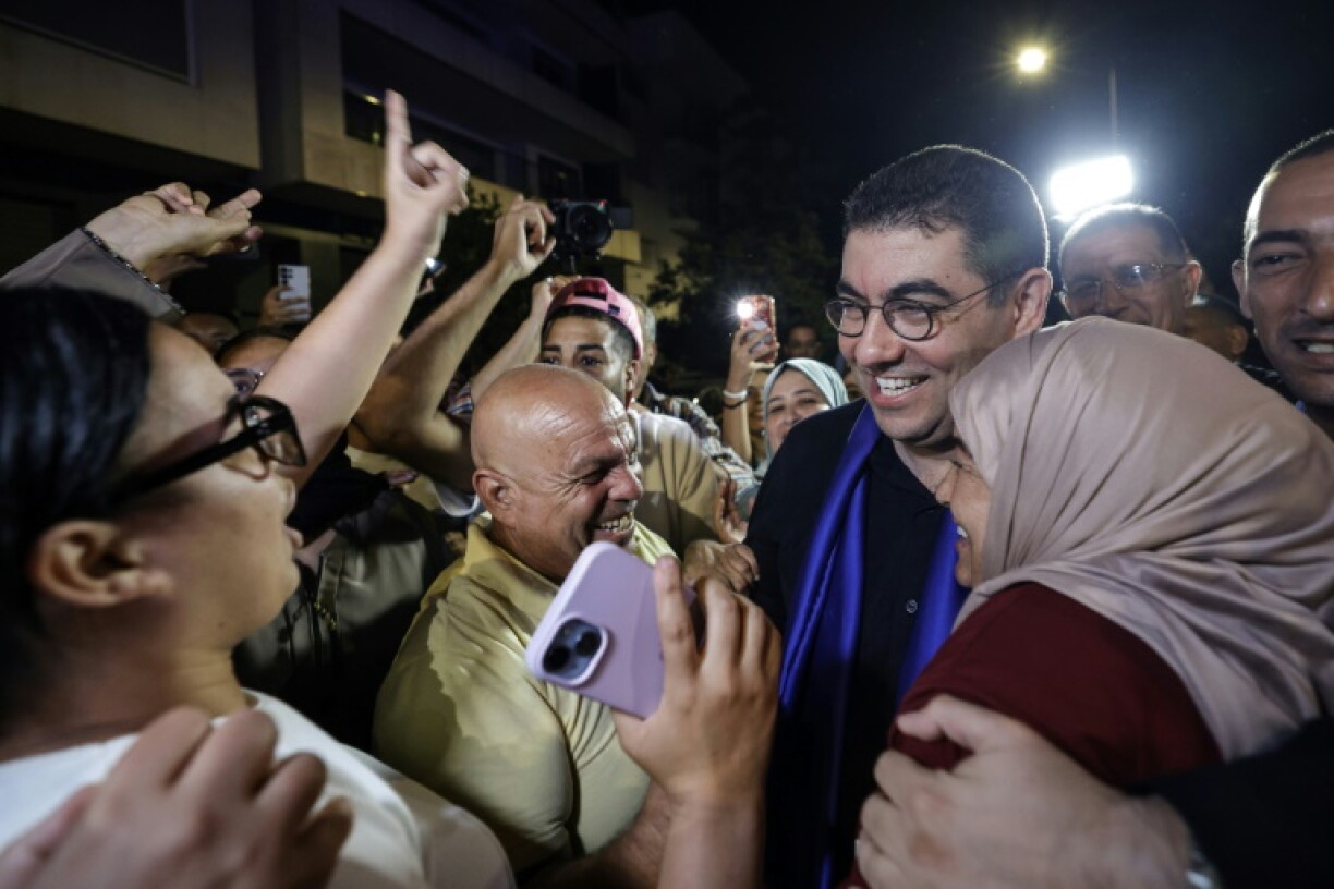 Morocco's Minister of Youth, Culture and Communication and member of the collective leadership of the Authenticity and Modernity Party (PAM), Mohamed Mehdi Bensaid (2nd R), celebrates with party members after the announcement of the provisional results of the legislative elections in the early hours of September 24, 2026. Morocco's centre-right Authenticity and Modernity Party (PAM), which is part of the kingdom's ruling coalition, came out ahead in September 23's parliamentary election after winning 97 out of 395 seats, according to provisional results.