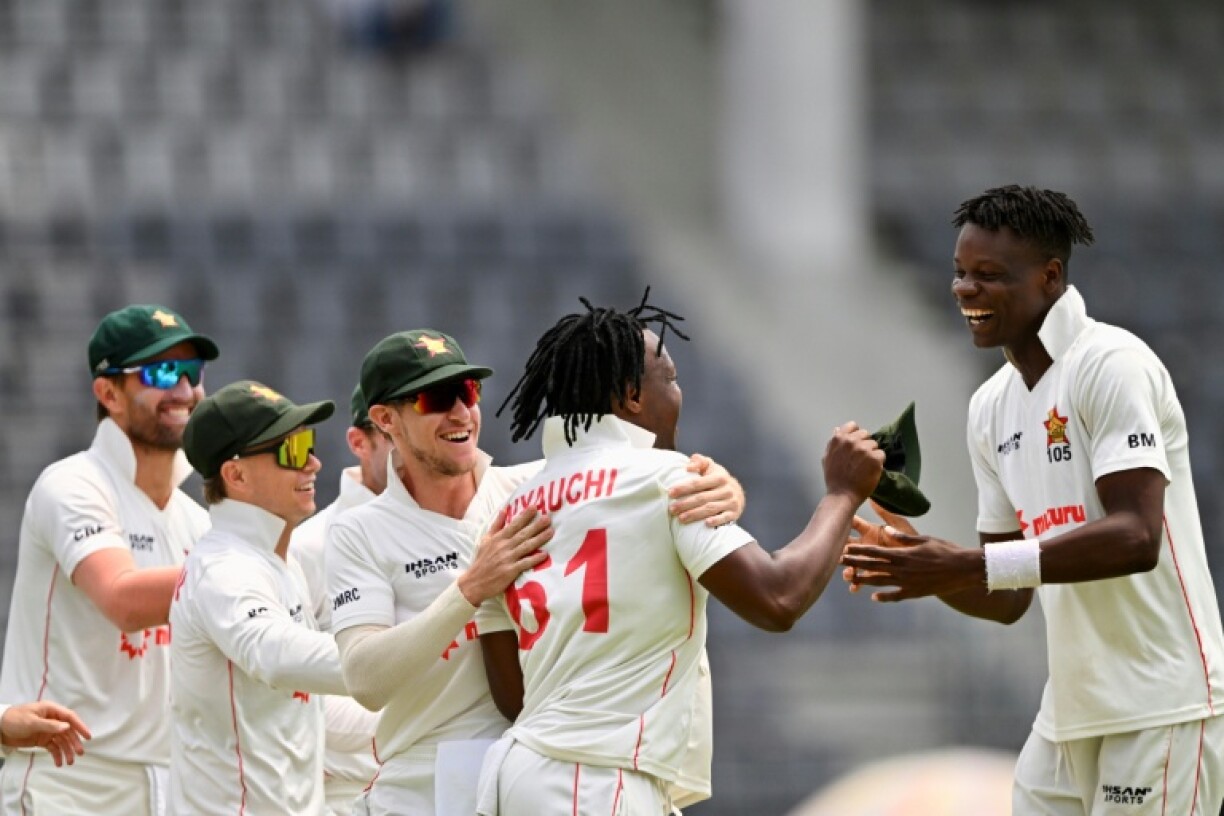Zimbabwe's Blessing Muzarabani (R) celebrates with his teammates after taking the wicket of Bangladesh's captain Najmul Hossain Shanto