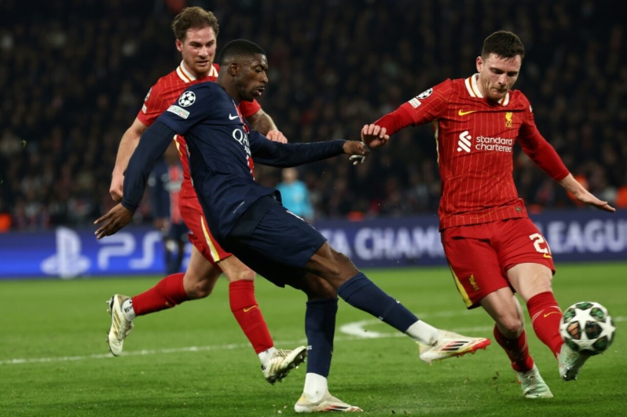 Ousmane Dembele is challenged by Andy Robertson during the Champions League last-16 first leg between Paris Saint-Germain and Liverpool