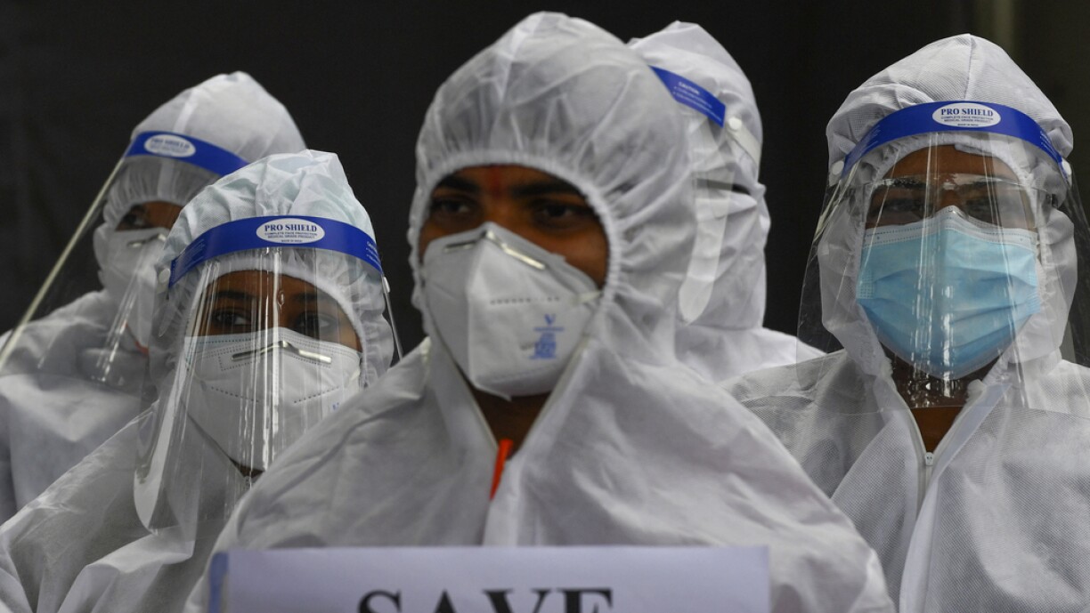 Doctors and nurses wearing protective gear take part in a protest outside a Covid-19 coronavirus care facility against the alleged mismangement and wrongful termination of staff, in Mumbai July 5, 2021.