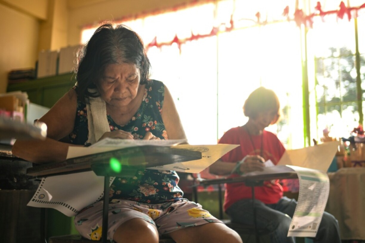 People vote at a polling station during mid-term elections in Manila on Monday