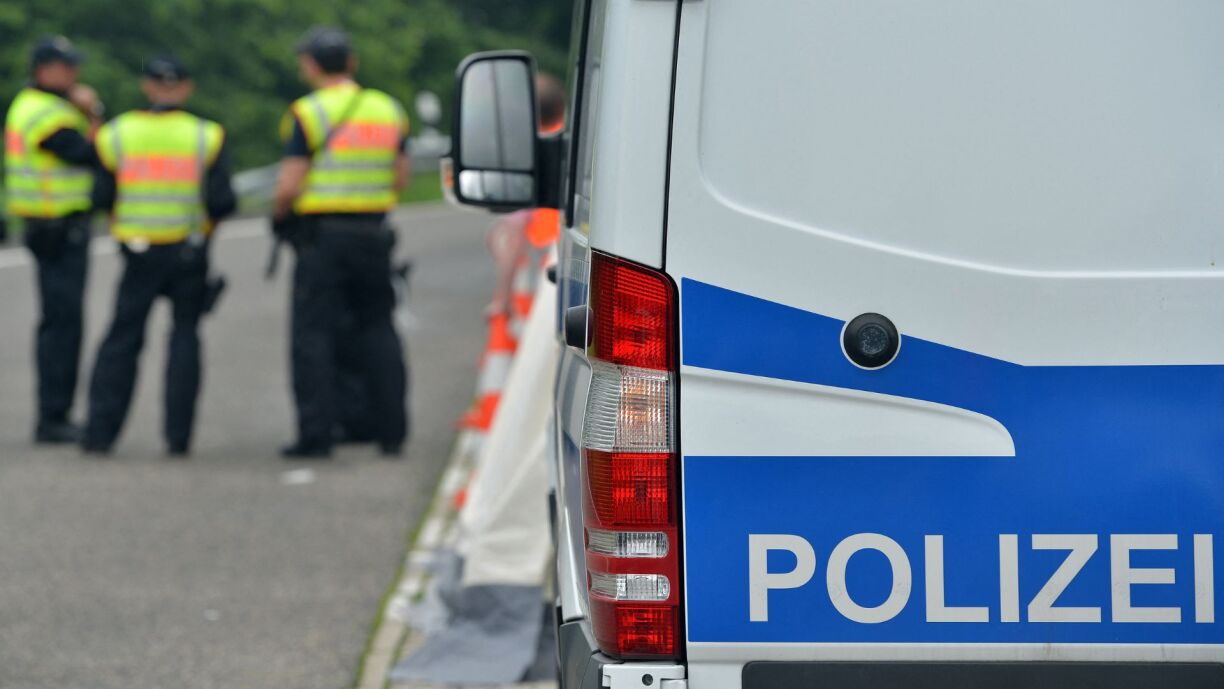 Members of the German Federal Police seen next to a police vehicle during traffic checks on a car park along the A 64 motorway near Trier, Germany, 12 June 2016.