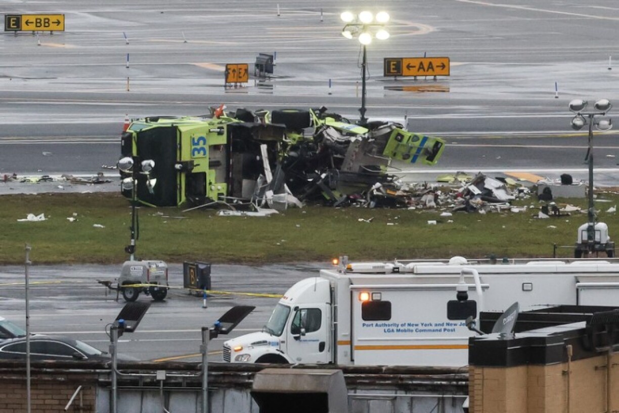 A damaged Port Authority fire truck sits near the runway after colliding with an Air Canada Express CRJ-900 at LaGuardia Airport in New York, on March 23, 2026