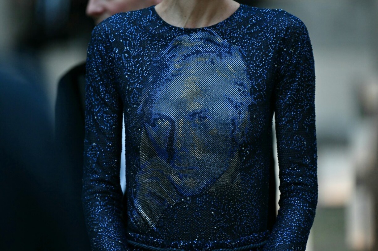 The final dress in the show, a sweeping blue glittering gown, featured the Armani's face, drawing applause