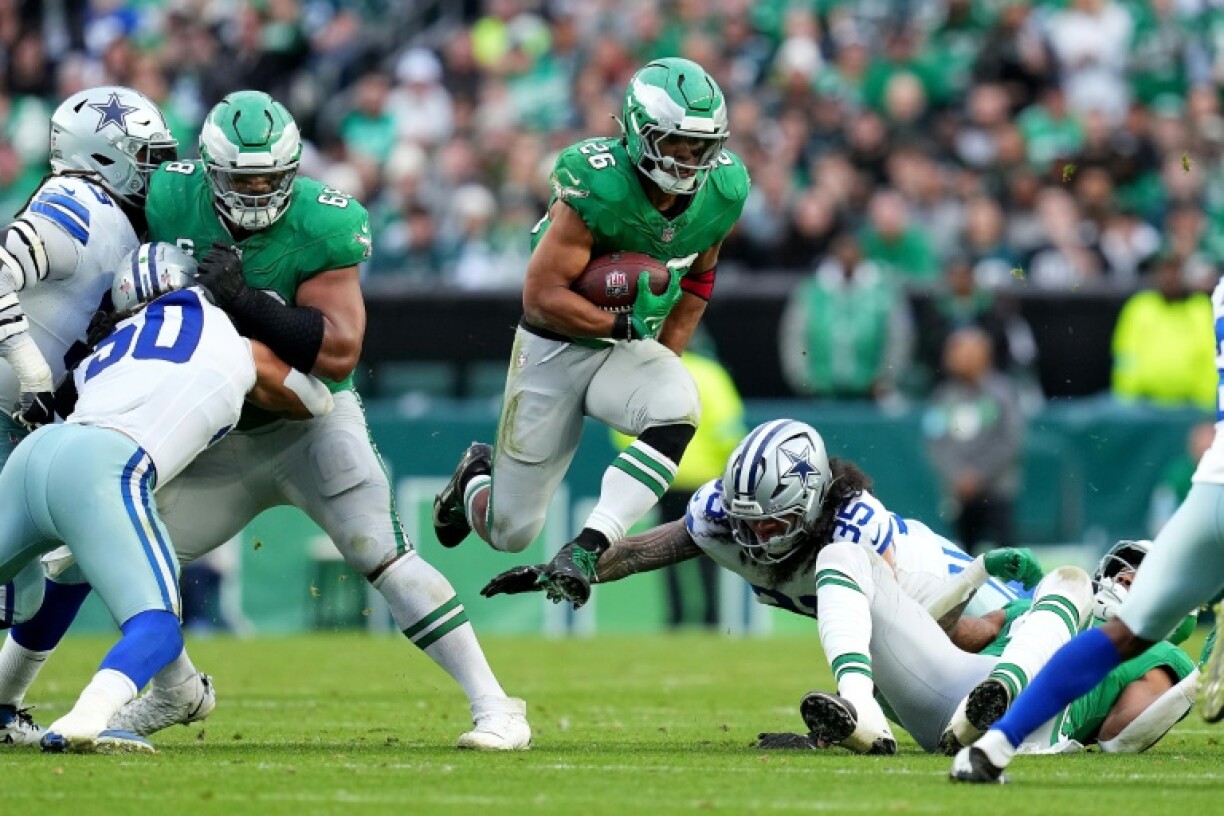 Saquon Barkley of the Philadelphia Eagles jumps over the tackle of Marist Liufau of the Dallas Cowboys in the Eagles' NFL victory over the Cowboys
