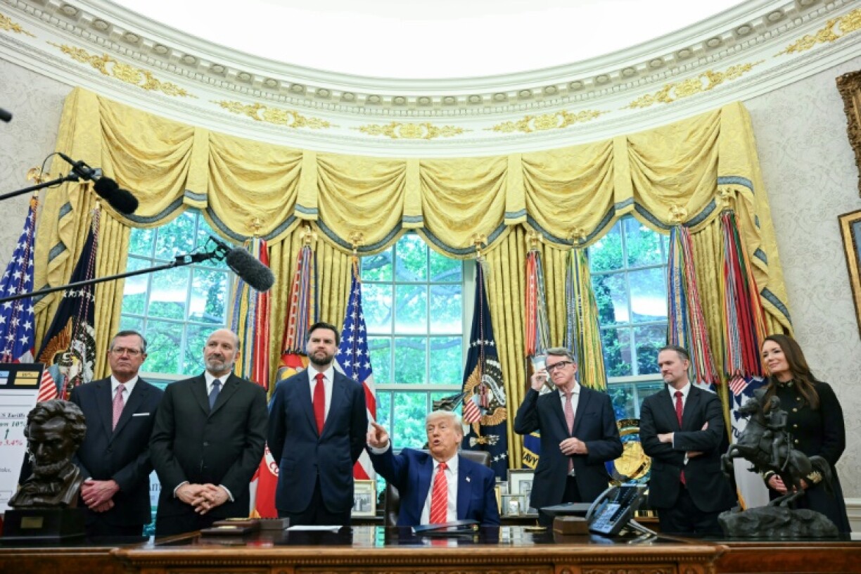 US President Donald Trump makes a trade announcement as US Secretary of Commerce Howard Lutnick (2L), US Vice President JD Vance (3L), British ambassador to the United States Peter Mandelson (3R), US Trade Representative Jamieson Greer (3R) and US Secretary of Agriculture Brooke Rollins (R) look on in the Oval Office of the White House in Washington, DC, on May 8, 2025. US President Donald Trump on announced a