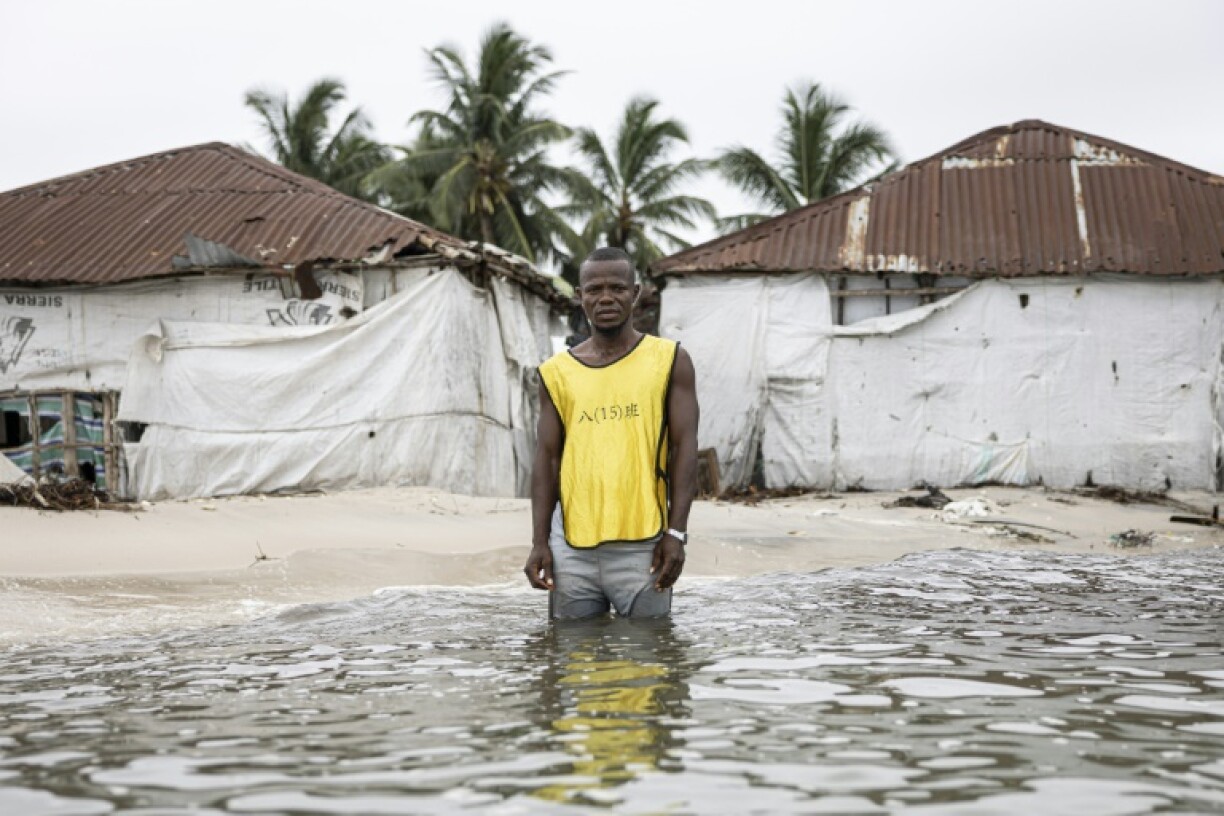 During high tide on Nyangai island, Hassan Kargbo shows AFP where buildings used to stand