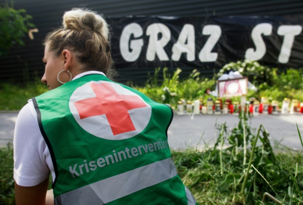 A member of a crisis intervention team next to candles in front of the school