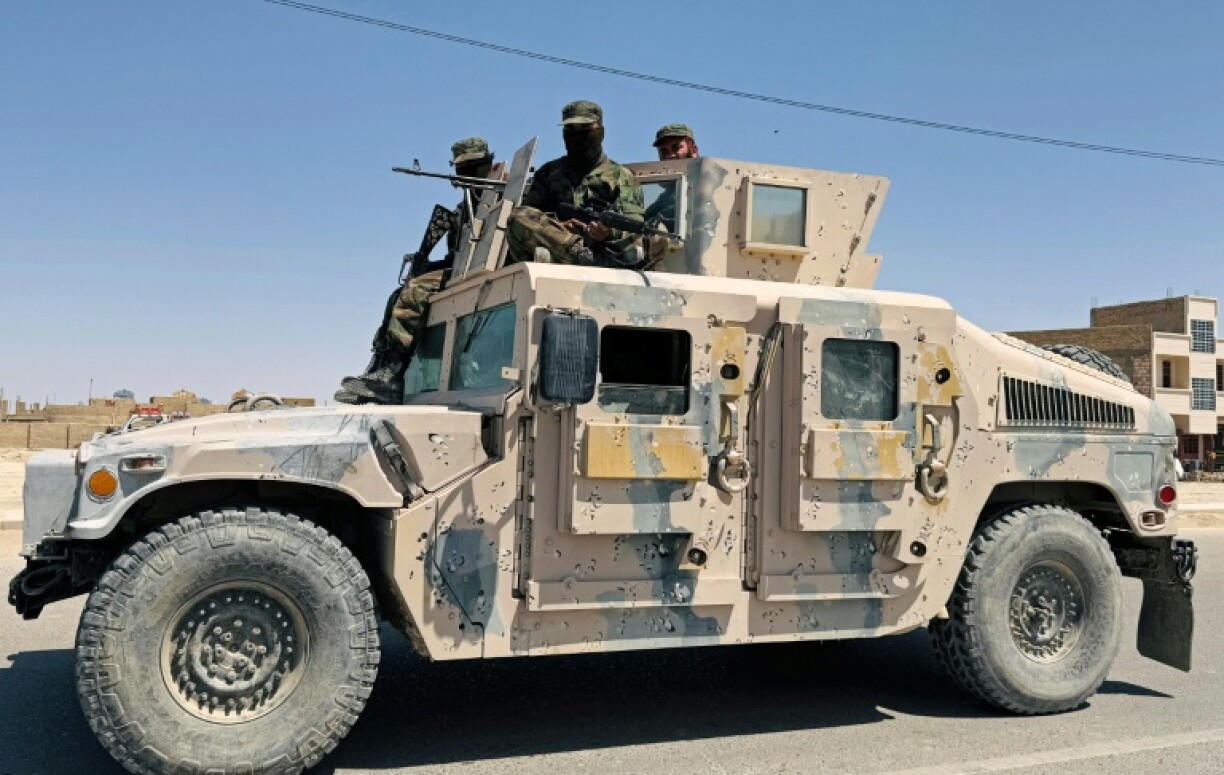Taliban security personnel patrol the city of Zaranj where a man was publicly executed at a football stadium