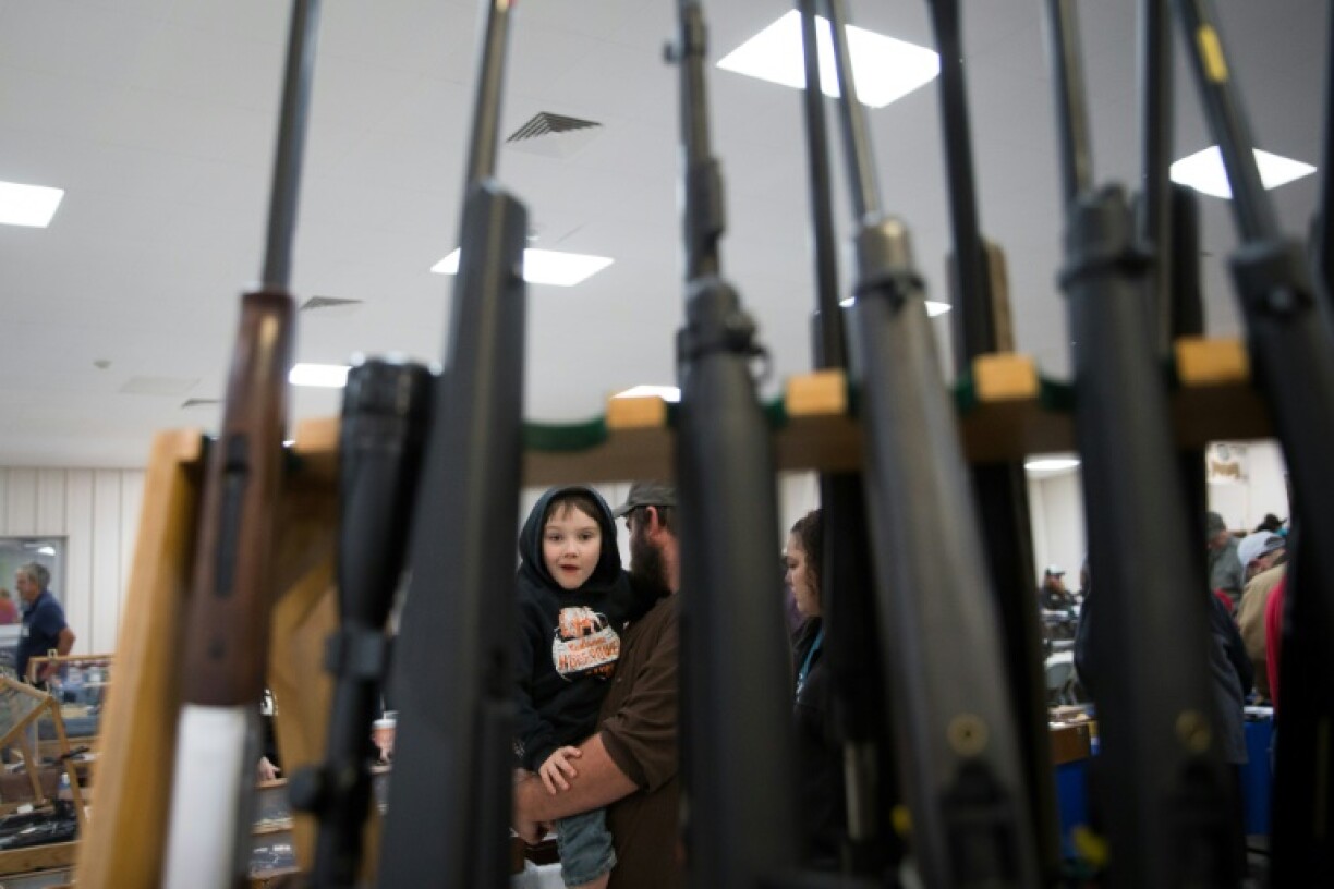 A young boy stares at a rack of guns inside a Sweetwater Rifle and Pistol Club show at Nolan County Coliseum on March 11, 2018 in Sweetwater, Texas