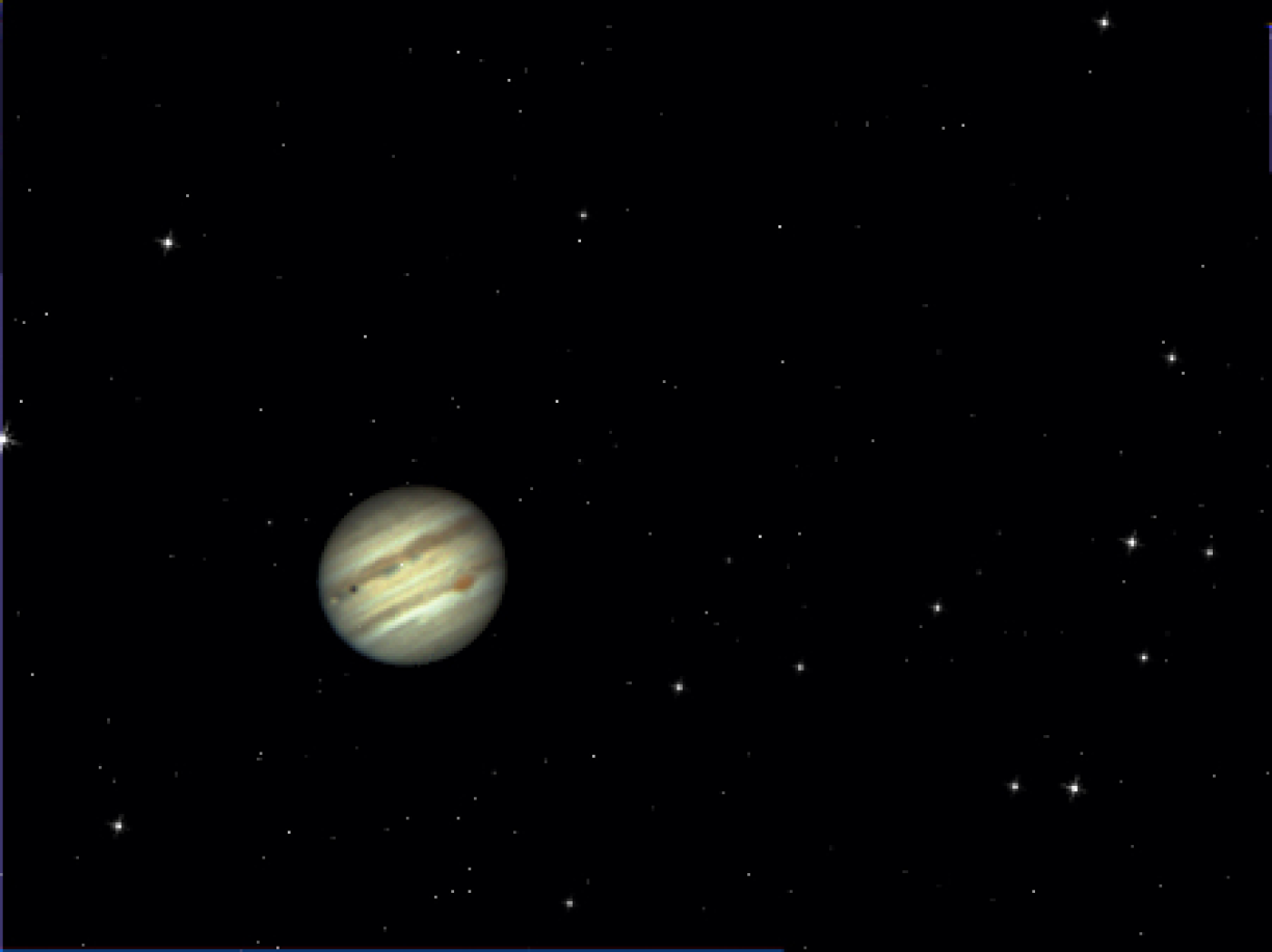 Io transiting in front of Jupiter, casting its shadow on the Gas Giant’s upper atmosphere.