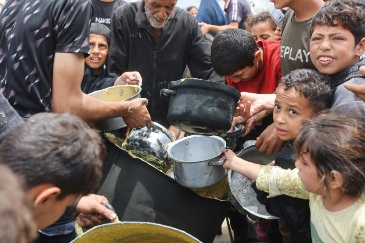 Palestinian children got a hot food ration from a charity kitchen at the Islamic University campus in Gaza City