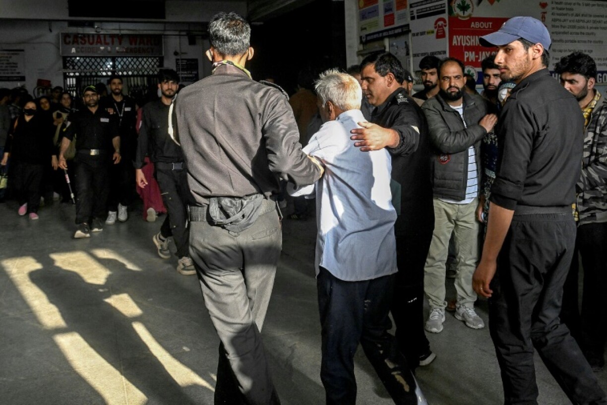 Paramedics assist an injured tourist at a hospital in Anantnag, south of Srinagar